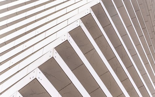 Close-up of a modern architectural facade featuring diagonal lines creating a dynamic pattern. The