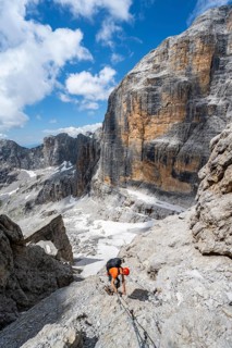 Climbers on the Via Ferrata Brentari via ferrata, spectacular mountain landscape with steep cliffs,
