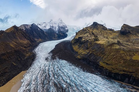 Stunning aerial capture of Vatnajökull Glacier winding through the rugged mountains of Vatnajökull