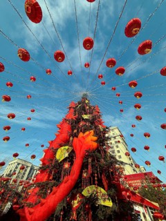 Vibrant Chinese New Year decorations adorn the streets with red lanterns and festive elements,