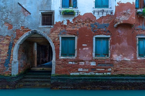 Old house with gate entrance to the canal, Venice, Veneto, Italy