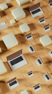 Multiple laptops arranged on a tiled background featuring abstract geometric shapes and blocks,