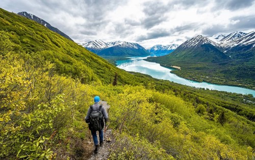 Climbers on a hiking trail, Slaughter Ridge Trail, view of snowy mountains in spring and turquoise