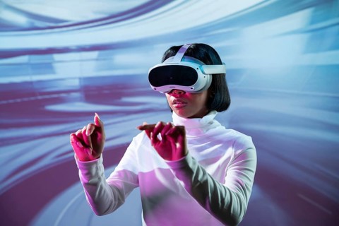 Latin woman immersed in a virtual reality experience, wearing VR glasses and interacting with a