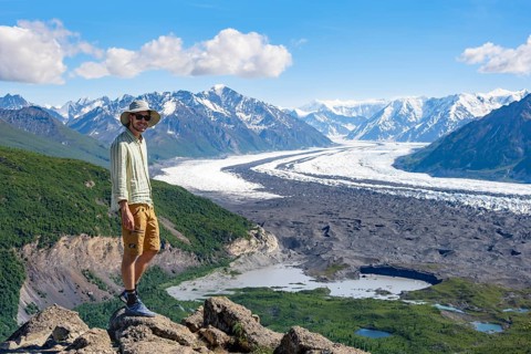Young man enjoying the view, view of impressive mountain landscape with Matanuska glacier and