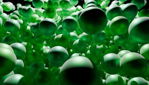 Dynamic and abstract composition of floating green spheres creating a vibrant and energetic scene.