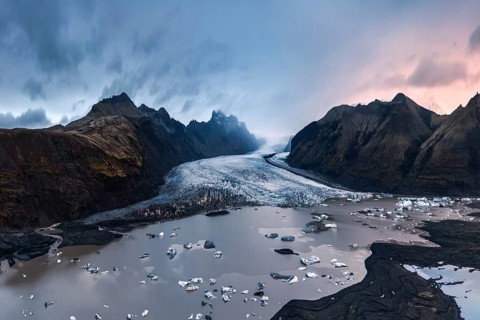 Majestic twilight view of Vatnajökull Glacier, Iceland, with scattered icebergs and dramatic