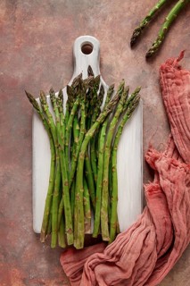 Bouquet of fresh asparagus, on an abstract background, top view, rustic, no people