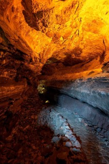 Underground cave formed by lava flow, illuminated lava tunnel, Cueva de los Verdes, Lanzarote,