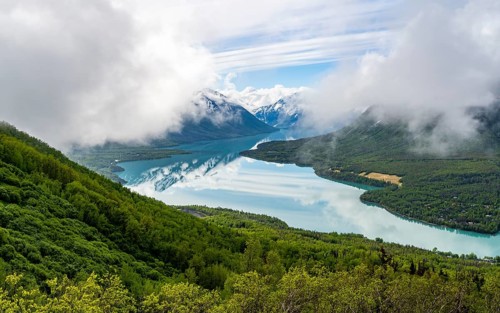 View of snowy mountains in spring and turquoise blue Kenai Lake, Slaughter Ridge Trail, Cooper