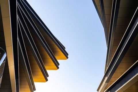 This image showcases the dynamic lines and sleek surfaces of modern architecture against a clear