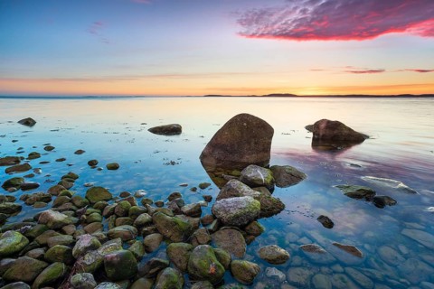 Rocky beach with boulders on the Bay of Greifswald at sunset, Mönchgut Nature Reserve, Groß Zicker,
