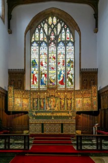 Stained glass east window, elaborately carved gilt altar reredos screen 1938, church of Saint John