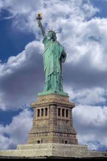 Statue of Liberty in front of New York, cloudy sky, USA