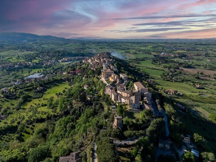 Aerial view of Treia, Italy, capturing the historic architecture and lush countryside under a