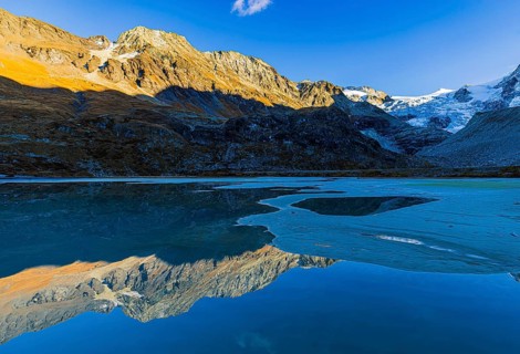 The Moiry glacier and mountain peaks are reflected in Lac de Chateaupre, Val d'Anniviers, Valais