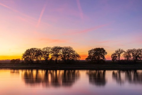 Colourful evening sky after sunset on the Elbe in Kreinitz, Saxony, Germany