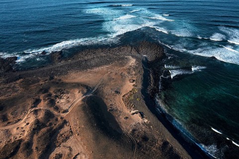 Aerial view of Popcorn Beach, striking coastline with natural volcanic landscapes contrasting