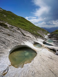 Glacier mill with glacier pots on the Trinser Alp Mora, Trin, Canton Graubünden, Switzerland