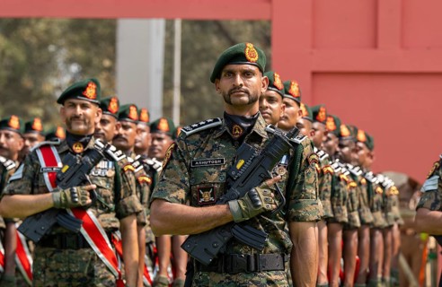 Central Reserve Police Force (CRPF) personnel wearing ceremonial headgear stand in formation during