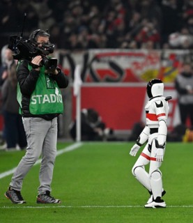 During the DFL and VfB Stuttgart Innovation Matchday, an AI-supported robot hands over the Adidas