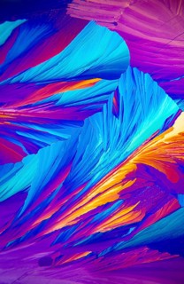 Microscopic image showcasing vivid Adipic acid, crystals in stunning shades of blue, purple, and