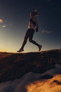 Trail running in autumn on the Jochberg on Lake Walchensee against the wonderful backdrop of the