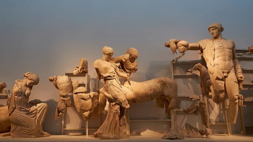On the right, the god Apollo, west pediment of the Temple of Zeus, battle between lapiths and
