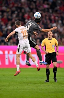 Florian Wirtz Bayer 04 Leverkusen (10) v Min-jae Kim FC Bayern Munich FCB (03) Referee Referee