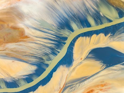 From above, this striking aerial shot captures vibrant natural textures and a sinuous river amidst