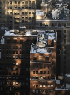 Top view of a New York City block capturing buildings bathed in the golden light of sunset,