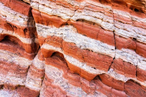 This image captures the intricate patterns of red rock strata, highlighting varying tones and