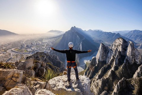 Man embraces breathtaking views while practicing mountaineering and rappelling in Eagleâ€™s Nest,