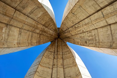 Symmetrical view of the concrete arches of a modern monument, The National Independence Monument in