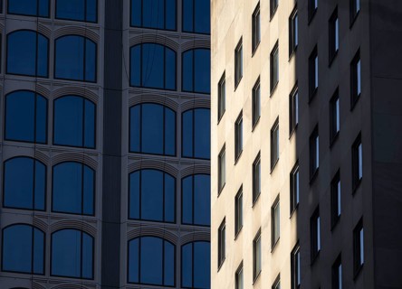 Architectural styles of two adjacent modern buildings in New York, capturing their unique facades