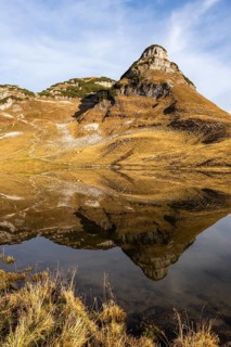 Lake Augstsee and the Atterkogel mountain on the Loser. Autumn, good weather, blue sky. Reflection.