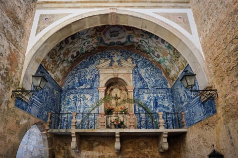 Historic chapel inside Porta da Senhora da Piedade in Obidos, with blue azulejo tiles, painted