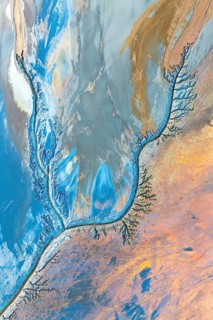 Abstract fractal work featuring dynamic patterns in vibrant blues, oranges, and earth tones. The