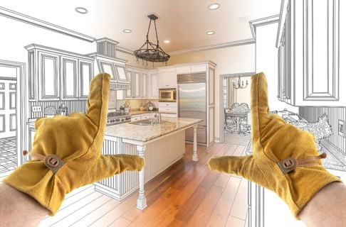 Male Contractor Hands Framing Completed Section of Custom Kitchen Design Drawing