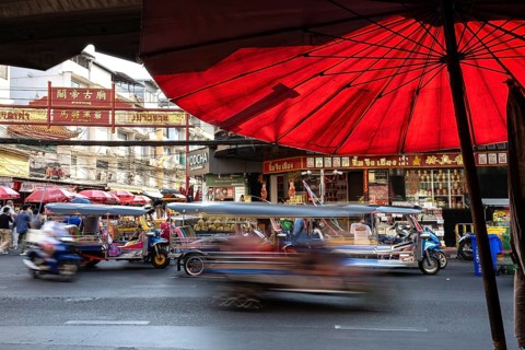 Bangkok, Thailand. March 25th 2025. Busy evening traffic of tuk-tuk and taxis passing popular
