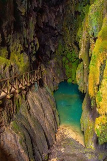 Beautiful colours inside the Iris Grotto at the Cola de Caballo Waterfall in the Monasterio de