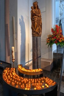 Sculpture of the Virgin Mary in front of sacrificial candles, St Kilian's Cathedral, Würzburg,