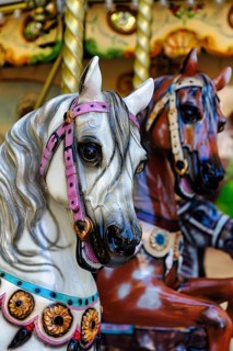 Two horse figures, horse heads, horses in a nostalgic children's carousel, close-up, France