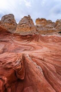 Striking view of the swirling red and beige rock formations of White Pocket, located in Arizona's