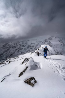 Ski tourer, ascent to the summit of the Köllkuppe or Cima Marmota, snow-covered mountain landscape,