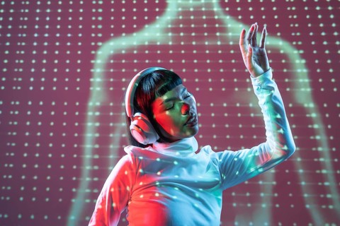 A futuristic Latin woman enjoys music through headphones. Immersed in the sound, her expression