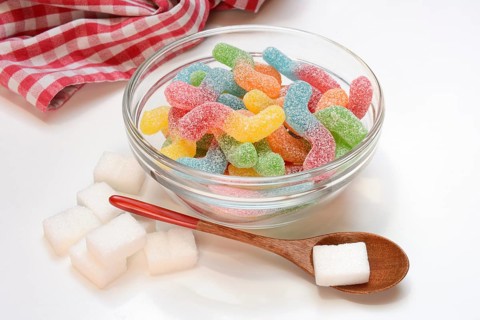 Lots of colorful jelly candies and sugar cubes, sugar consumption