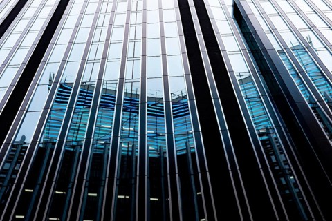 Modern abstract reflections in glass fronted commercial office buildings in the financial district