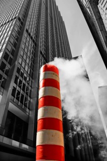 Steaming chimney at a construction site behind a skyscraper, New York City, USA