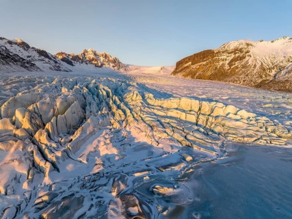The stunning beauty of the Skaftafell Glacier during winter. The sunlight accentuates the rugged